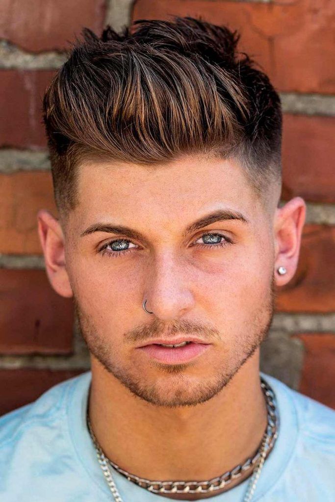 Free Photo  Male beauty concept portrait of a fashionable young man with  stylish haircut wearing trendy suit posing over red wall